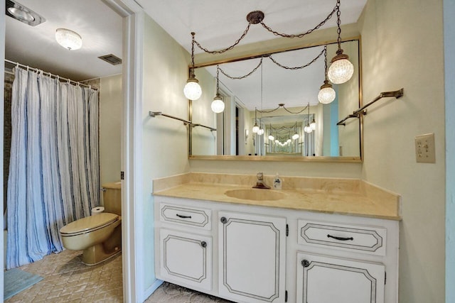 bathroom featuring vanity, toilet, and a shower with shower curtain