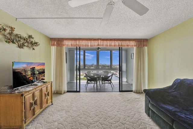 carpeted living room with ceiling fan and a textured ceiling