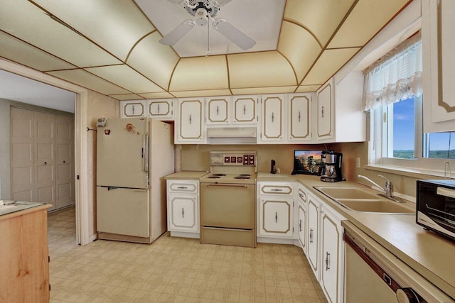 kitchen with range with electric stovetop, white refrigerator, ceiling fan, stainless steel dishwasher, and sink