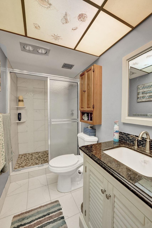 bathroom featuring walk in shower, vanity, and toilet