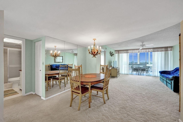 dining space featuring ceiling fan with notable chandelier, vaulted ceiling, and light carpet