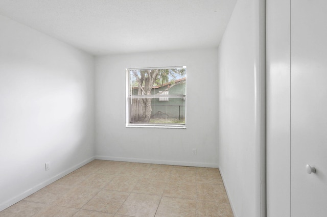 empty room featuring light tile patterned floors