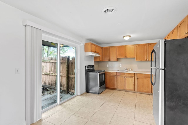 kitchen with appliances with stainless steel finishes, light tile patterned flooring, and sink