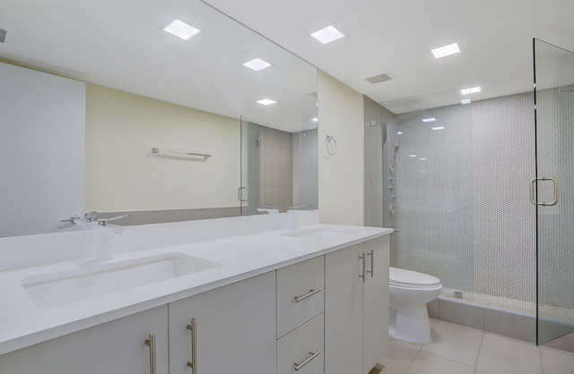 bathroom featuring tile patterned floors, a shower with door, vanity, and toilet