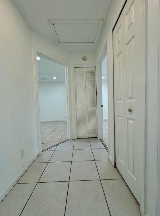 hall featuring light tile patterned floors