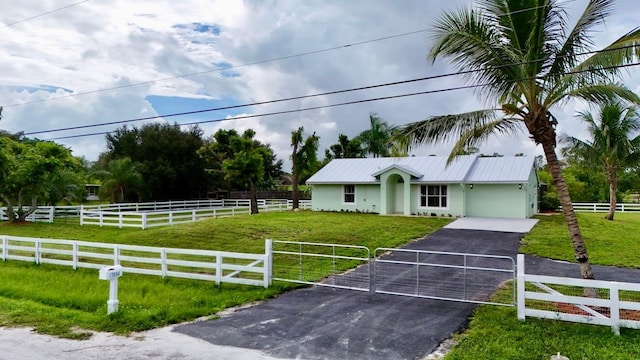 view of front facade with a front lawn and a rural view