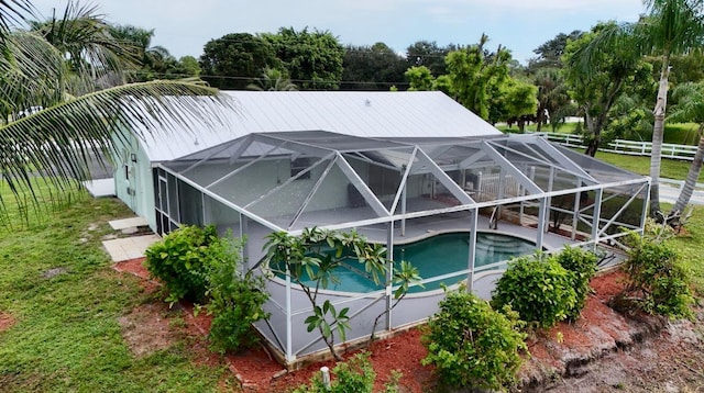 view of pool featuring glass enclosure and a patio area