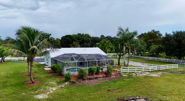 view of yard with a rural view and glass enclosure