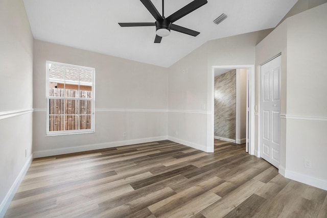 unfurnished room with wood-type flooring, ceiling fan, and lofted ceiling