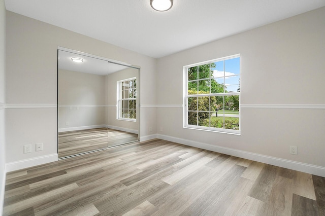 empty room with hardwood / wood-style floors