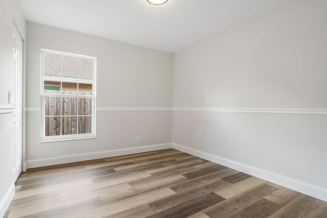 unfurnished room with hardwood / wood-style floors