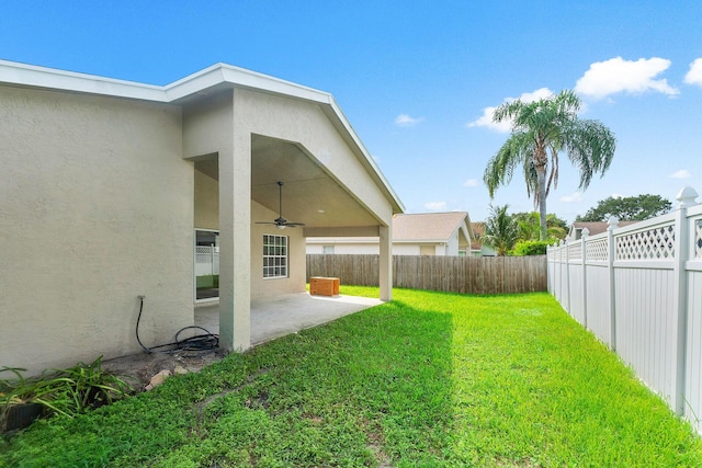 view of yard with a patio and ceiling fan