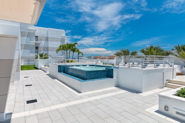 view of swimming pool with an in ground hot tub and a patio area