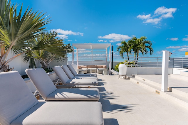 view of patio / terrace featuring a balcony, a water view, and outdoor lounge area