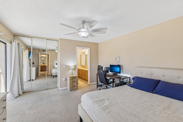 bedroom featuring a textured ceiling, ceiling fan, light colored carpet, and a closet