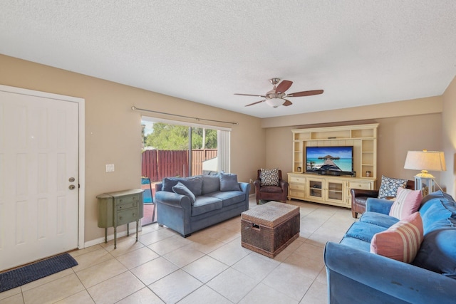 tiled living room with ceiling fan and a textured ceiling