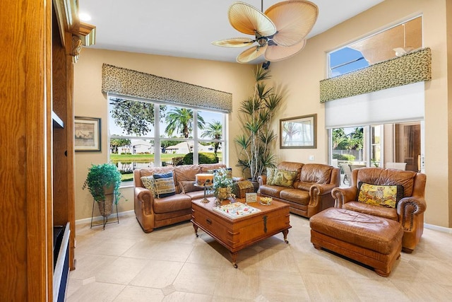 tiled living room featuring ceiling fan and vaulted ceiling