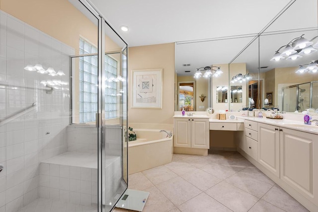 bathroom featuring tile patterned flooring, shower with separate bathtub, and vanity