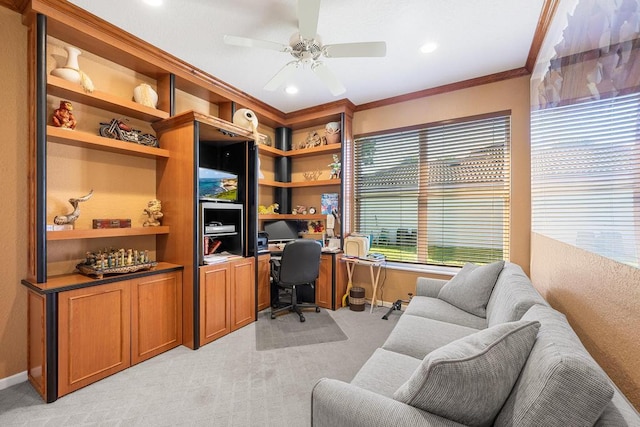 office featuring ceiling fan, crown molding, built in desk, and light colored carpet