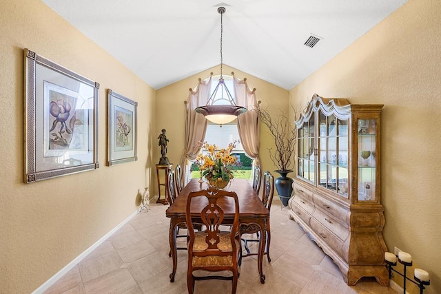 dining room featuring lofted ceiling