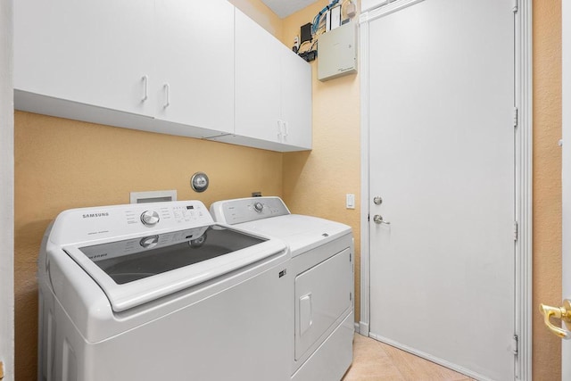 washroom featuring independent washer and dryer and cabinets