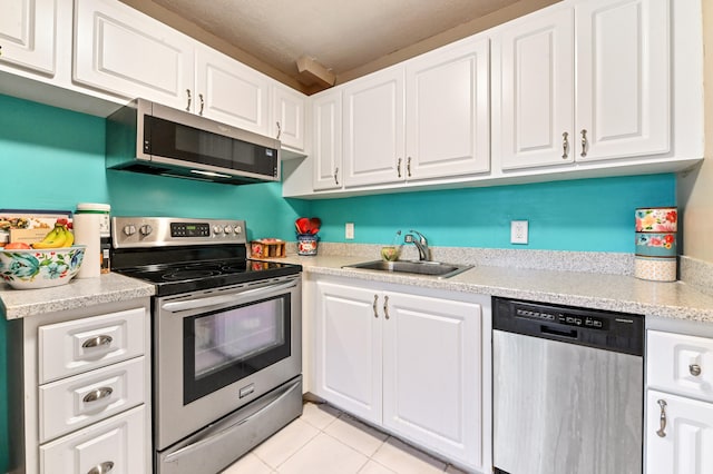 kitchen with sink, appliances with stainless steel finishes, and white cabinets