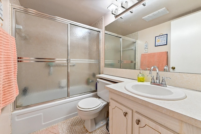 full bathroom featuring vanity, toilet, tile patterned floors, and shower / bath combination with glass door