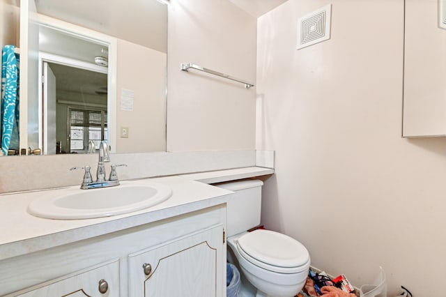 bathroom featuring toilet and vanity