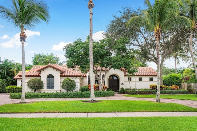 414 NW 13th St, Delray Beach, FL 33444 - mediterranean / spanish-style house with stucco siding, a tile roof, and curved driveway