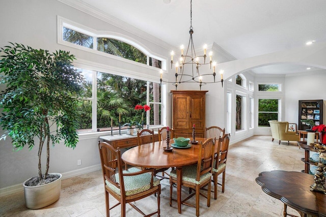 dining room with crown molding, a chandelier, and a high ceiling