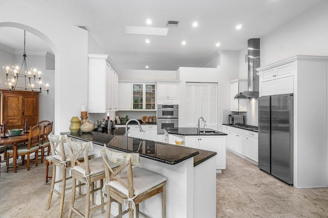 414 NW 13th St, Delray Beach, FL 33444 - kitchen with appliances with stainless steel finishes, a peninsula, wall chimney exhaust hood, crown molding, and a chandelier
