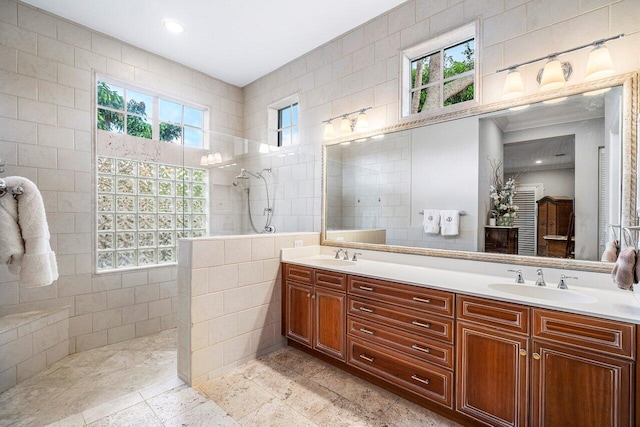 414 NW 13th St, Delray Beach, FL 33444 - full bath with tile walls, walk in shower, double vanity, healthy amount of natural light, and recessed lighting
