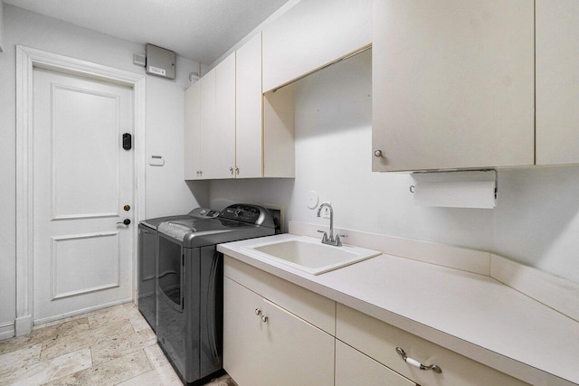 laundry area with cabinets, sink, and washing machine and clothes dryer