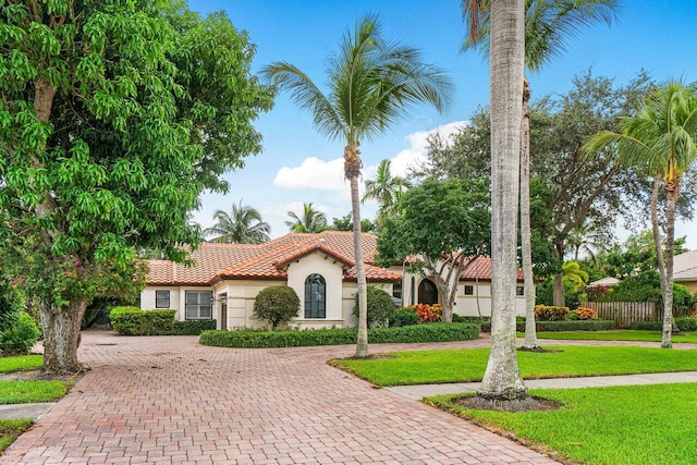 414 NW 13th St, Delray Beach, FL 33444 - mediterranean / spanish-style home featuring a tile roof, stucco siding, and curved driveway