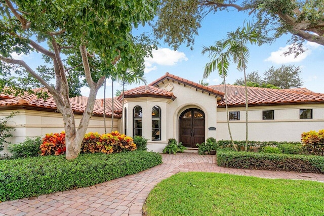 414 NW 13th St, Delray Beach, FL 33444 - mediterranean / spanish house featuring a tile roof and stucco siding