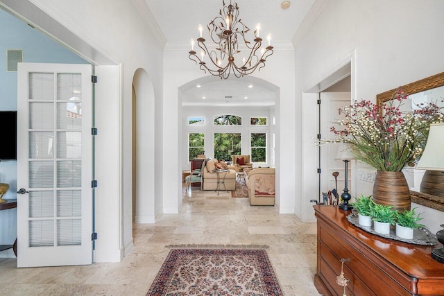 414 NW 13th St, Delray Beach, FL 33444 - entrance foyer with arched walkways, ornamental molding, a chandelier, and baseboards