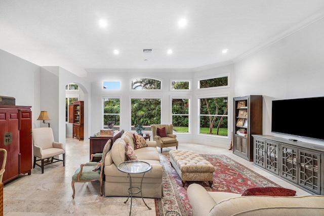 living room featuring ornamental molding, a textured ceiling, and plenty of natural light