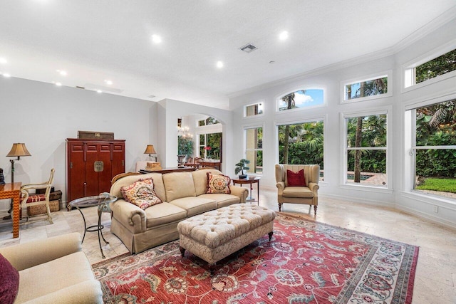 living room featuring an inviting chandelier, crown molding, and a textured ceiling