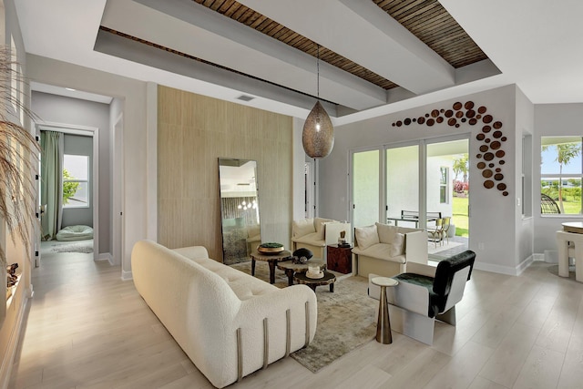 living room with beam ceiling and light hardwood / wood-style floors