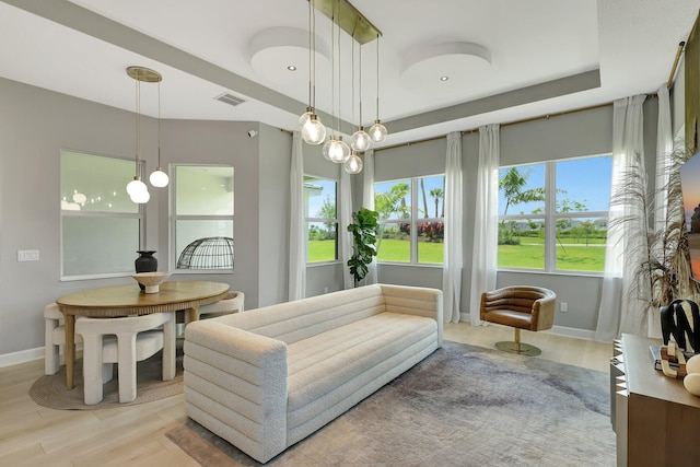 living area featuring light hardwood / wood-style flooring and a notable chandelier