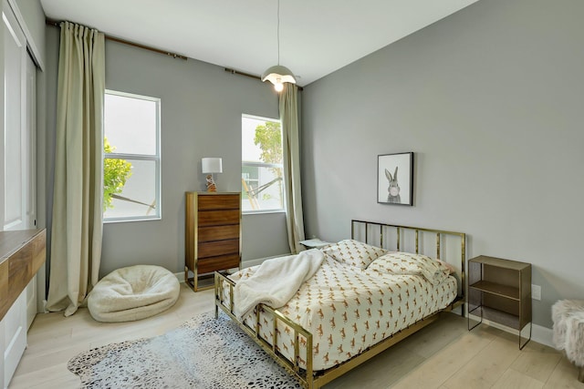 bedroom featuring light hardwood / wood-style floors and multiple windows