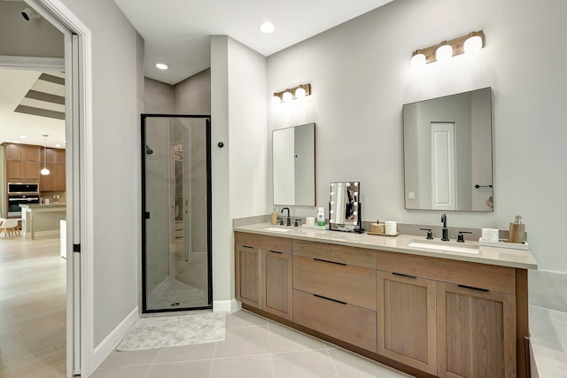 bathroom with tile patterned flooring, vanity, and a shower with door