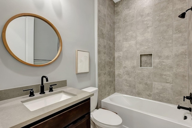 full bathroom with tiled shower / bath, vanity, and toilet