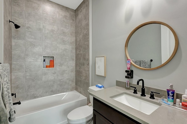 full bathroom with tiled shower / bath, vanity, and toilet