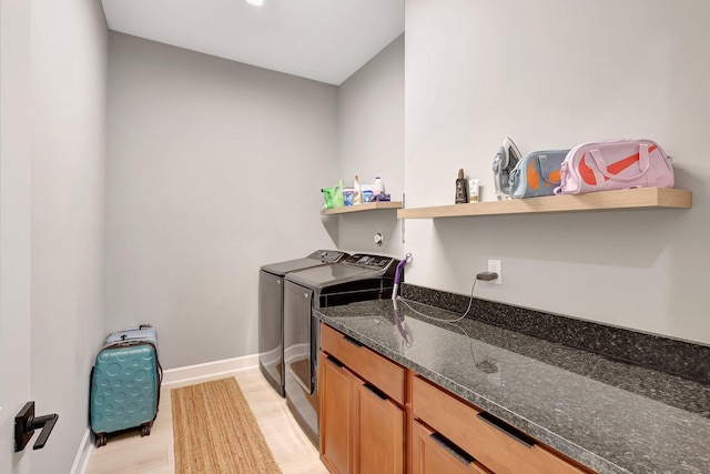 washroom featuring washing machine and clothes dryer and light wood-type flooring