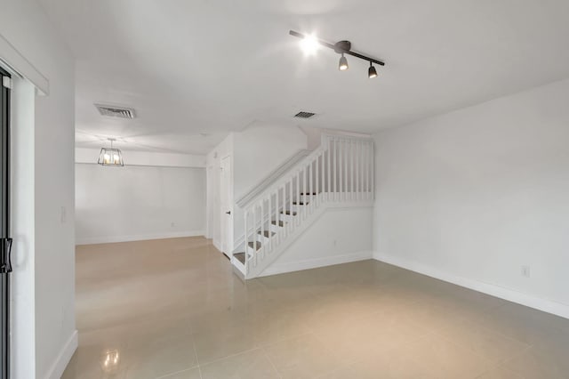 unfurnished room with an inviting chandelier