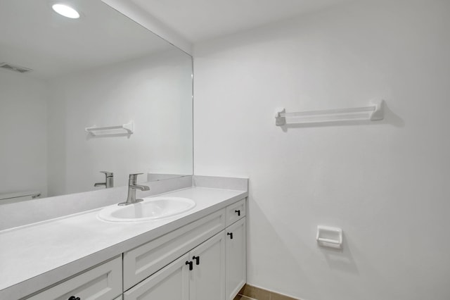 bathroom with vanity, toilet, and tile patterned floors