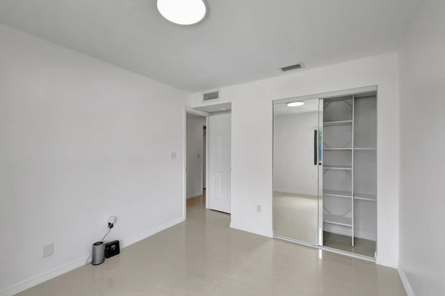 unfurnished bedroom with a closet and tile patterned floors