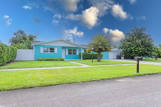 ranch-style home with a garage and a front lawn