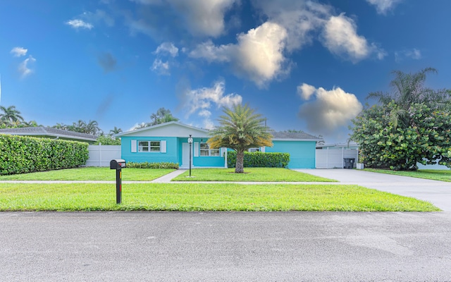 view of front facade with a front yard and a garage